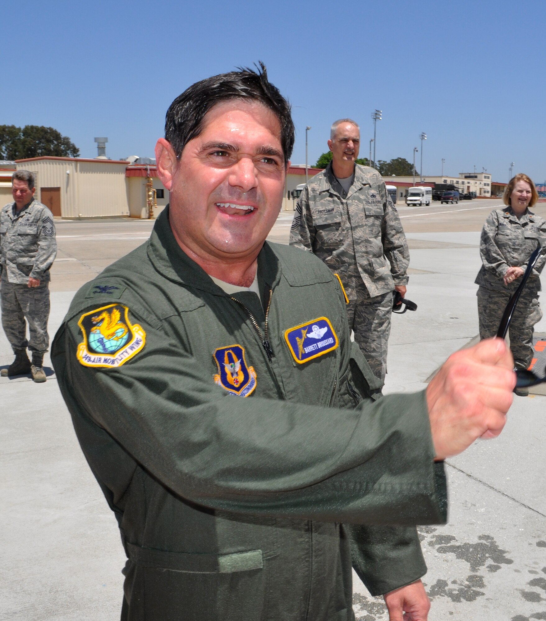 TRAVIS AIR FORCE BASE, Calif. -- "I wanted to take her round just one more time," said Col. Barrett Broussard, as he took his "fini" flight in a Team Travis C-17 June 24. Col. Broussard was met on the flight line by about 50 Airmen, family and friends who hosed him down as tradition dictates. (U.S. Air Force photo/Senior Master Sgt. Ellen L. Hatfield)