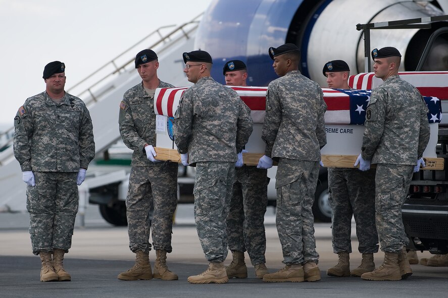 A U.S. Army carry team transfers the remains of Army Spc. Nicholas C. Hensley, of Prattville, Ala., at Dover Air Force Base, Del., June 30, 2011. Hensley was assigned to the 4th Squadron, 4th Cavalry Regiment, 1st Heavy Brigade Combat Team, 1st Infantry Division, Fort Riley, Kan. (U.S. Air Force photo/Steve Kotecki)
