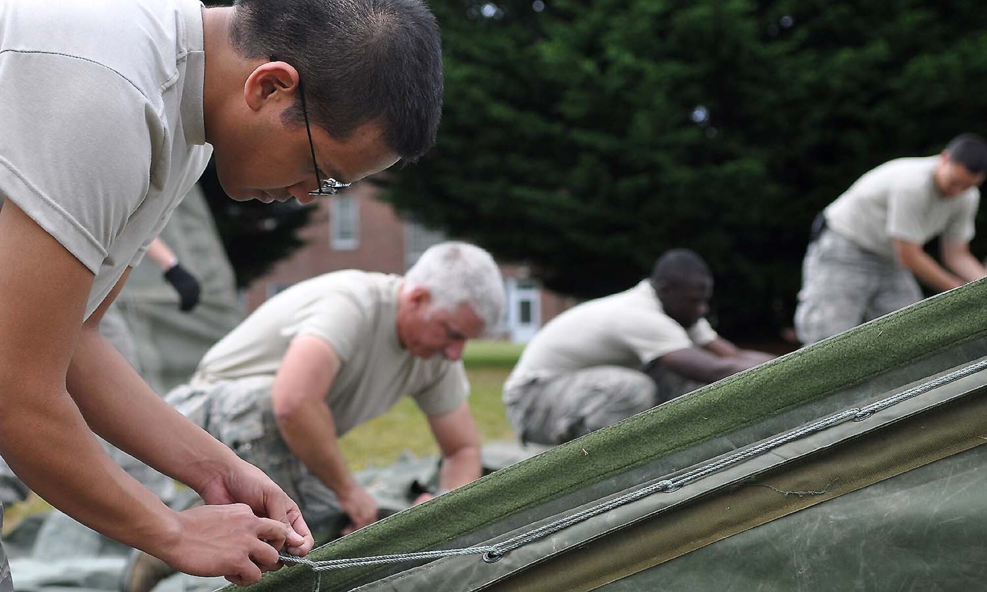 Airmen assigned to the 627th Civil Engineering Squadron, 62nd Maintenance Squadron and 446th Airlift Wing set up tents at Heritage Hill June 21 at Joint Base Lewis-McChord, Wash. Rainier Ranch construction began June 20 and is slated to be done by the second week of July. (U.S. Air Force photo/Airman 1st Class Leah Young)