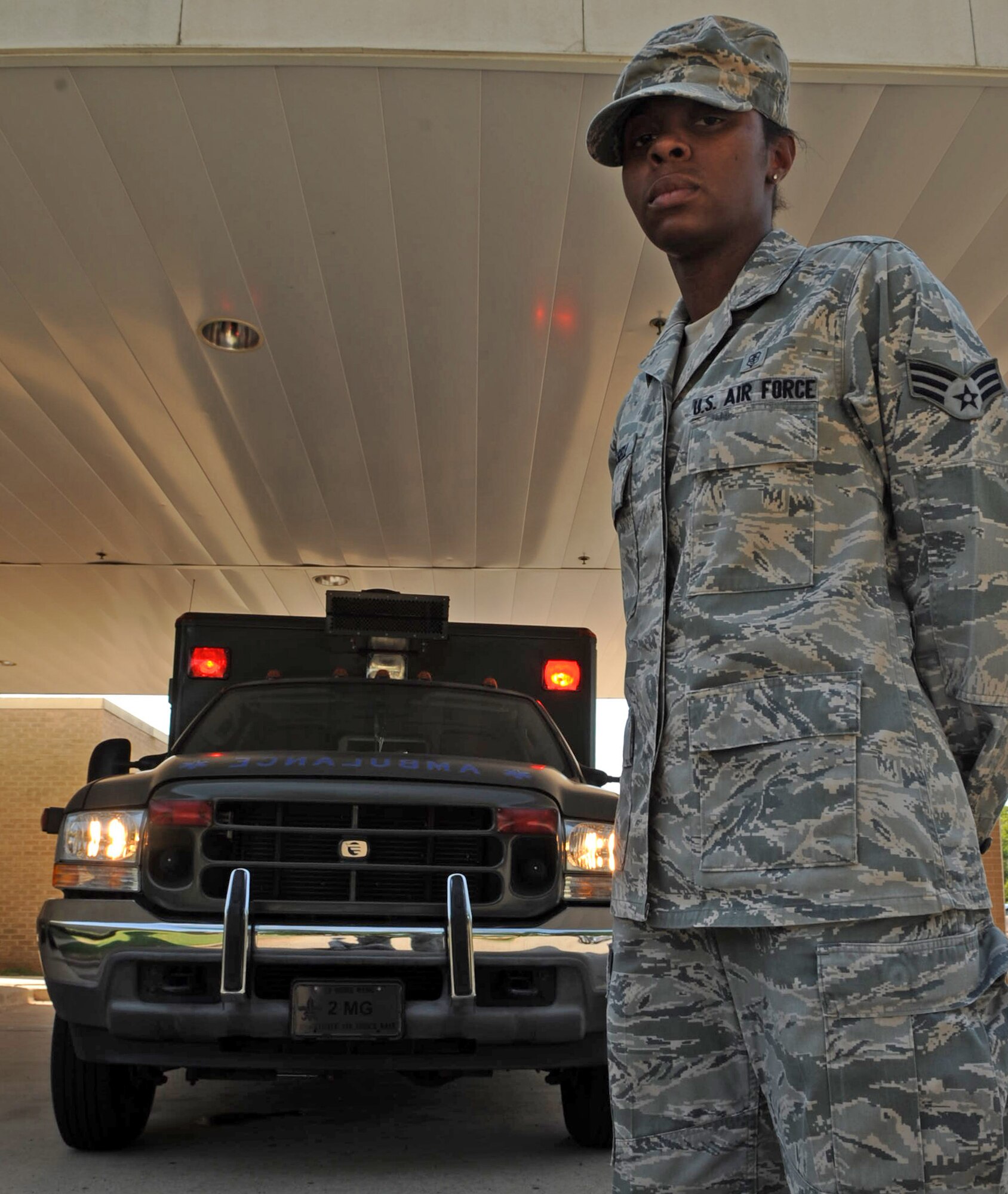 Senior Airman Jasmine Russell, 2nd Medical Operations Squadron, stands at parade rest in front of an ambulance on Barksdale Air Force Base, La., June 29. Airman Russell recently returned from her first deployment. On her deployment she sustained injuries due to an improvised explosive device that hit the vehicle she was traveling in. Despite her injuries, Airman Russell continued to provide medical care to the injured after the blast. (U.S. Air Force photo/Airman 1st Class Micaiah Anthony)(RELEASED)