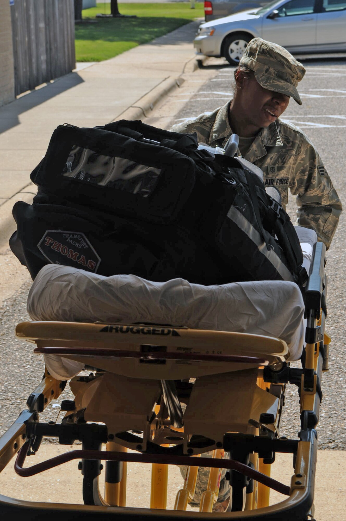 Senior Airman Jasmine Russell, 2nd Medical Operations Squadron, pulls a gurney from the back of an ambulance on Barksdale Air Force Base, La., June 29. Airman Russell recently returned from her first deployment in Afghanistan. On her deployment she sustained injuries due to an improvised explosive device that hit the vehicle she was traveling in. Despite her injuries, Airman Russell continued to provide medical care to the injured after the blast. (U.S. Air Force photo/Airman 1st Class Micaiah Anthony)(RELEASED)