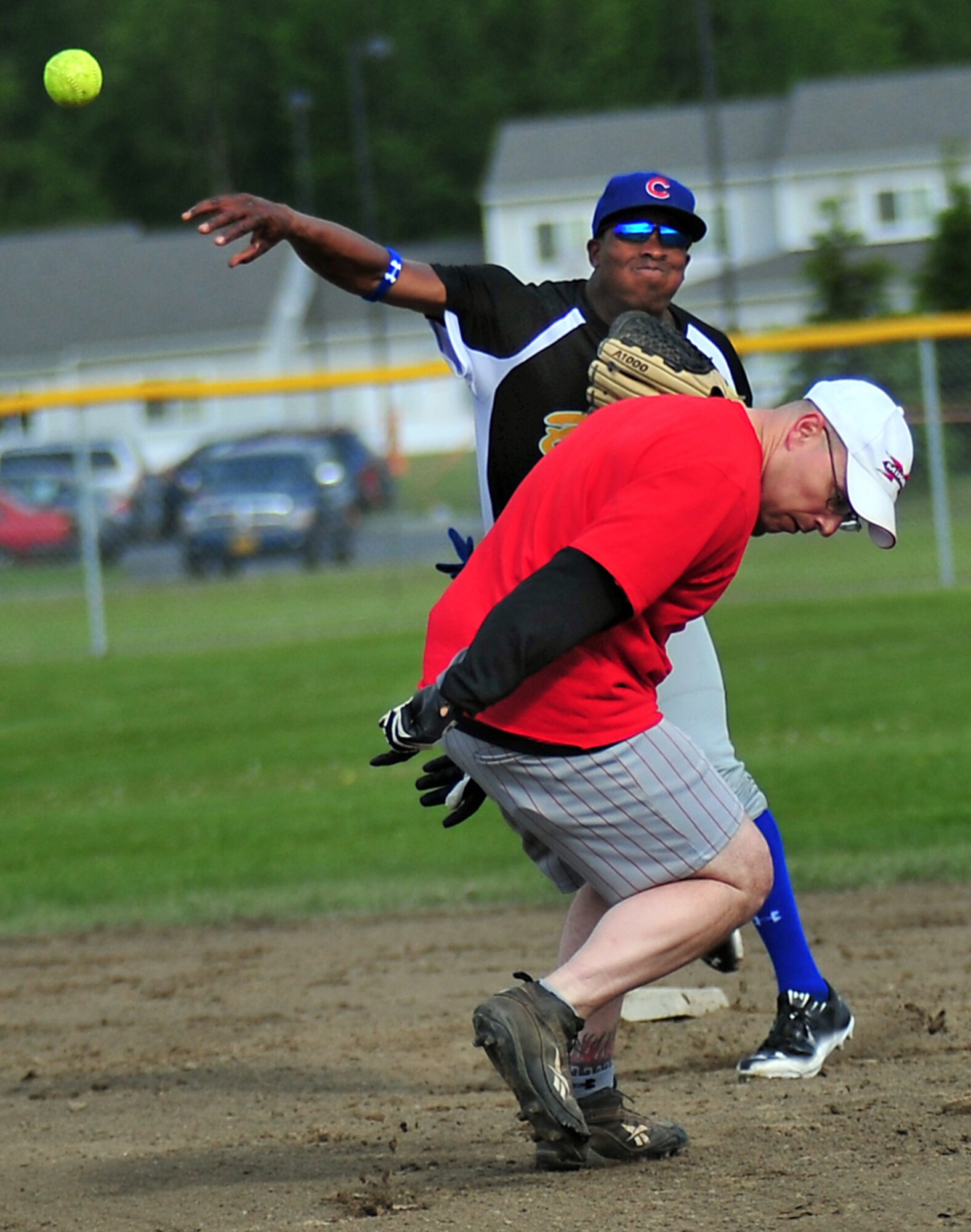 JOINT BASE ELMENDORF-RICHARDSON, Alaska???Spc. Thomas Scott,  B Company 3rd Battalion (Airborne) 509th Infantry Regiment, throws to first after catching 1st Sgt. Al Mariner, 425th Brigade Special Troops Battalion, out at second base, during a  intramural softball game between B Company 3rd Battalion (Airborne) 509th Infantry Regiment and 425th Brigade Special Troops Battalion at Joint Base Elmendorf-Richardson, Wednesday, June 22, 2011.  (U.S. Air Force photo/JBER POA, Justin Connaher)