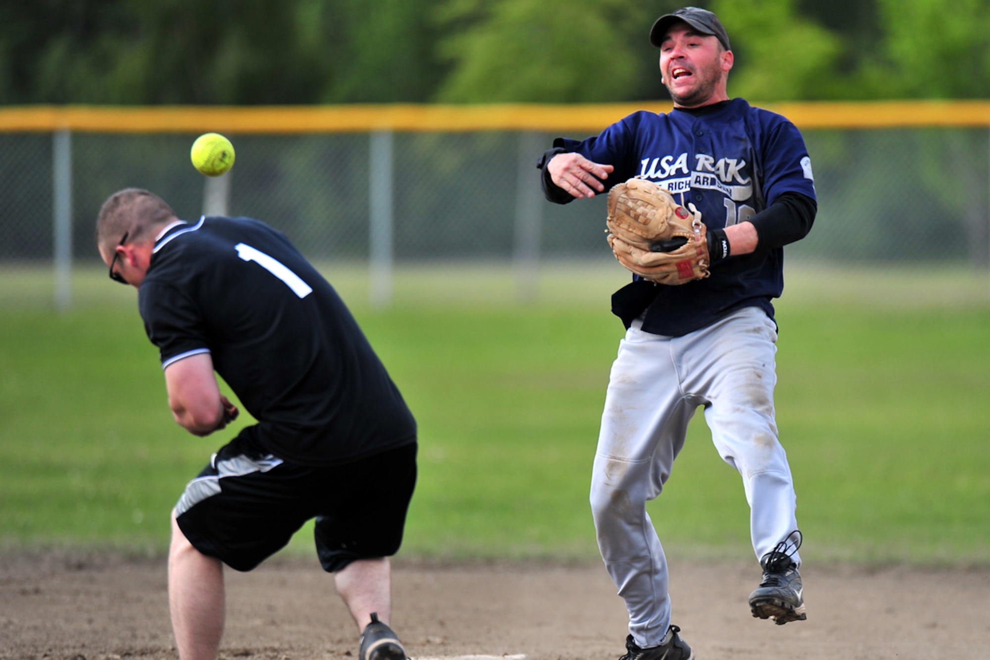 JOINT BASE ELMENDORF-RICHARDSON, Alaska???Sgt. 1st Class Jeremy Burnett, HHC 17th Combat Sustainment Support Battallion (Provisional), throws to first after catching Sgt. Dale Thurman,  B Company 2nd Battallion 377th Parachute Field Artillery Regiment, out at second base during the intramural softball game between 673rd Force Support Squadron and B Company 2nd Battallion 377th Parachute Field Artillery Regiment at Joint Base Elmendorf-Richardson, Wednesday, June 22, 2011.  (U.S. Air Force photo/JBER POA, Justin Connaher)
