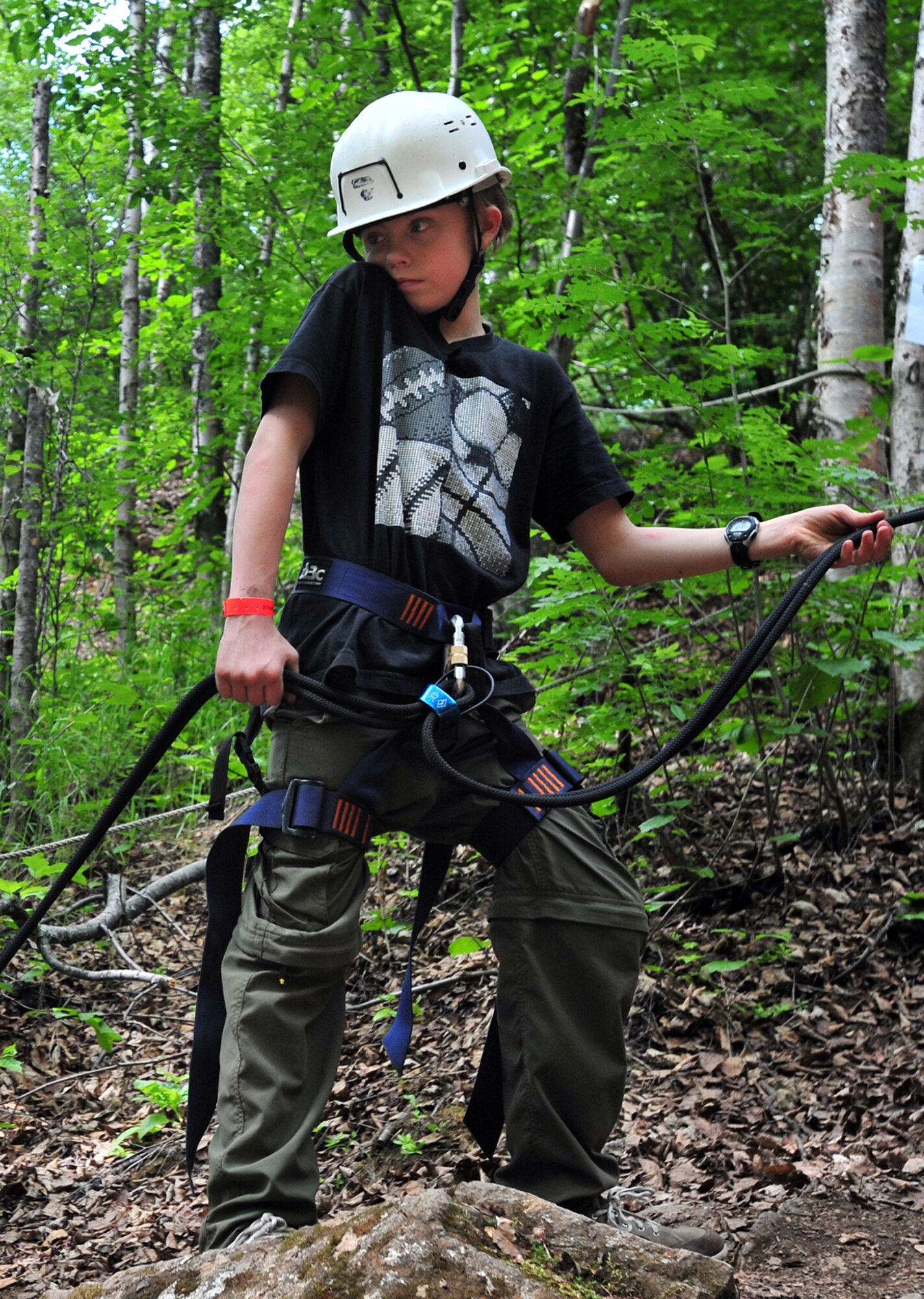 CAMP GORSUCH, Alaska???Tenderfoot Trentin Wermers, 12, of JBER Troop 190, holds a rappeling line for a fellow scout at Camp Gorsuch Boy Scout camp where Boy Scout troops 109 and 504 from Joint Base Elmendorf-Richardson were camping for the week and performing tasks to earn scouting badges, Thursday, June 23, 2011.  (U.S. Air Force photo by Justin Connaher/JBER PA)