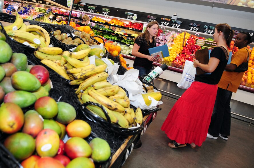 Misty Poye (left), wife of 1st Lt. Michael Poye, 2nd Logistics Readiness Squadron, asks Jennifer Coney (center), 2nd Aerospace Medicine Squadron Health and Wellness Center dietician, a question about the proper way to prepare exotic fruits during a commissary tour on Barksdale Air Force Base, La., June 30. The purpose of the tour was to educate Airmen and their families on recognizing and purchasing healthy foods. (U.S. Air Force photo/Senior Airman Joanna M. Kresge)