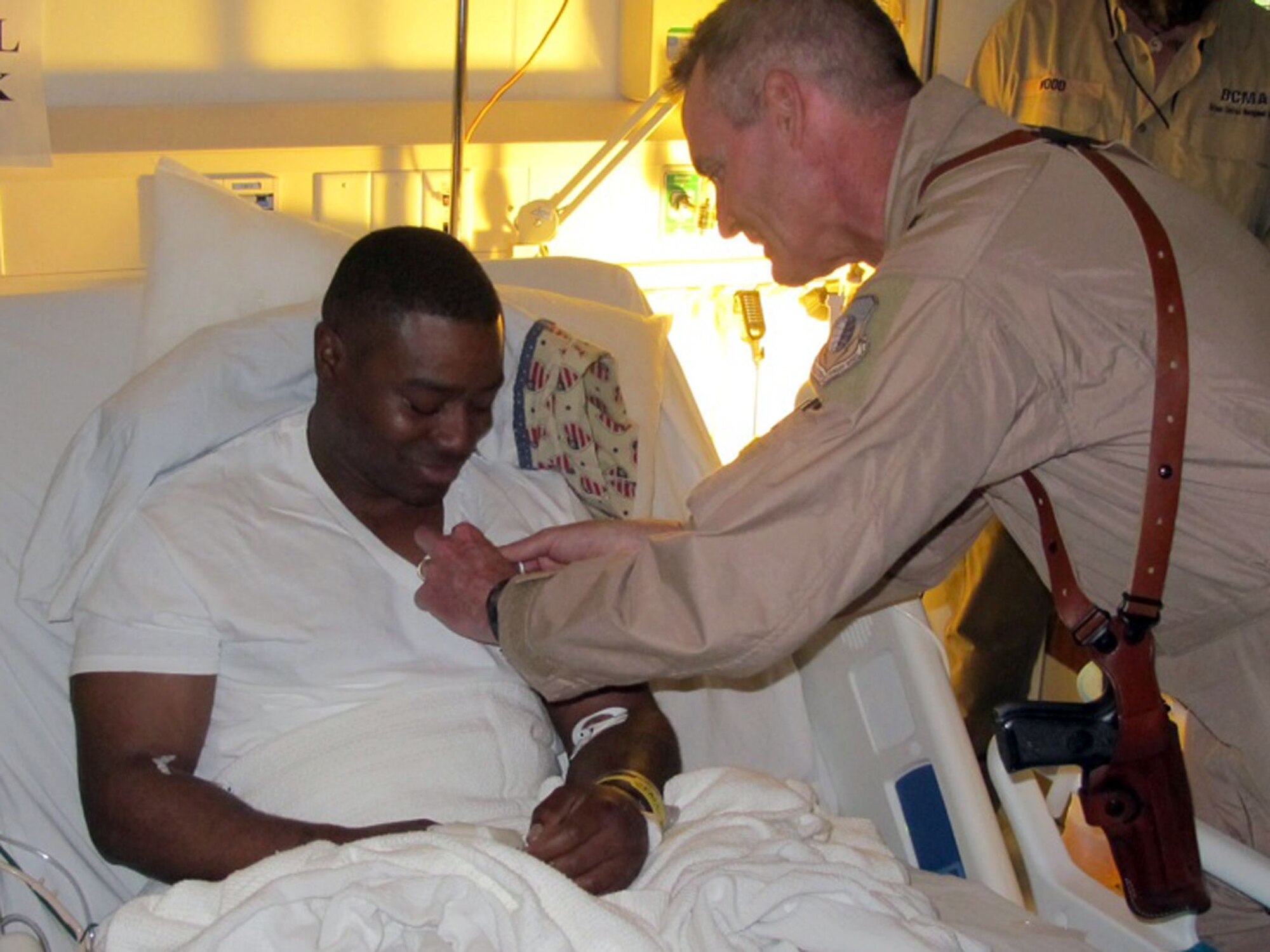 Brig. Gen. Darryl Roberson, 455th Air Expeditionary Wing commander, pins the Purple Heart on Tech. Sgt. John Knight, 2nd Civil Engineer Squadron firefighter, at Bagram Air Field, Afghanistan, May 7. Sergeant Knight was given the Purple Heart after a mortar landed on his living quarters in Jalalabad, Afghanistan, where he sustained multiple soft-tissue shrapnel wounds and a ruptured ear drum, May 6. (Courtesy photo)