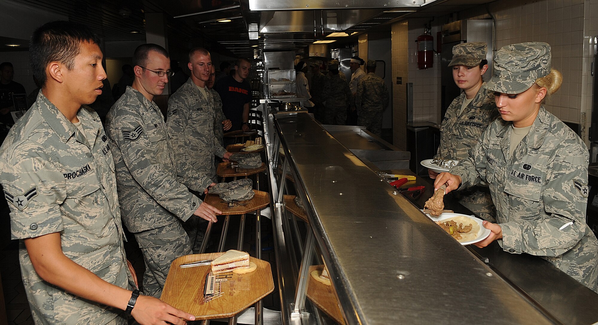 Airman 1st Class Kayla Dordell, 2nd Force Support Squadron, serves Airman 1st Class Anthony Prochaska, 2nd Logistics Readiness Squadron, in the Red River Dining Facility on Barksdale Air Force Base, La., June 29. The dining facility serves approximately 550 people per day, and offers healthy food choices for breakfast, lunch and dinner. (U.S. Air Force photo/Senior Airman Kristin High)(RELEASED)