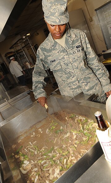 Airman 1st Class Jasmine Hyman, 2nd Force Support Squadron, mixes bell peppers and onions with chopped steak in the Red River Dining Facility on Barksdale Air Force Base, La., June 29. The dining facility serves approximately 550 people per day, and offers healthy food choices for breakfast, lunch and dinner.  (U.S. Air Force photo/Senior Airman Kristin High)(RELEASED)