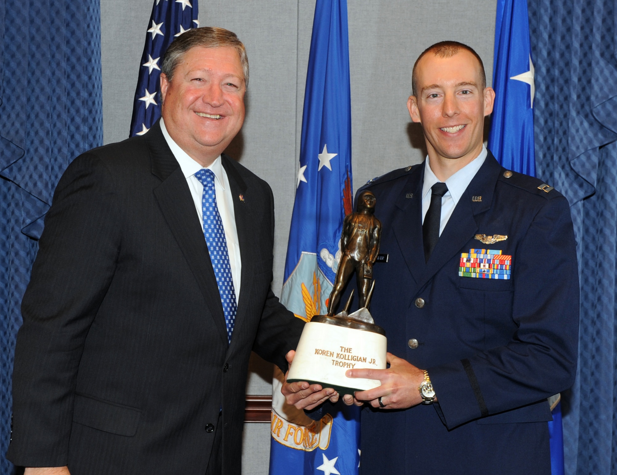 Secretary of the Air Force Michael Donley presents Capt. Hans Buckwalter with the 2010 Koren Kolligian Jr. Trophy June 29, 2011, during a ceremony in the Pentagon. (U.S. Air Force photo)