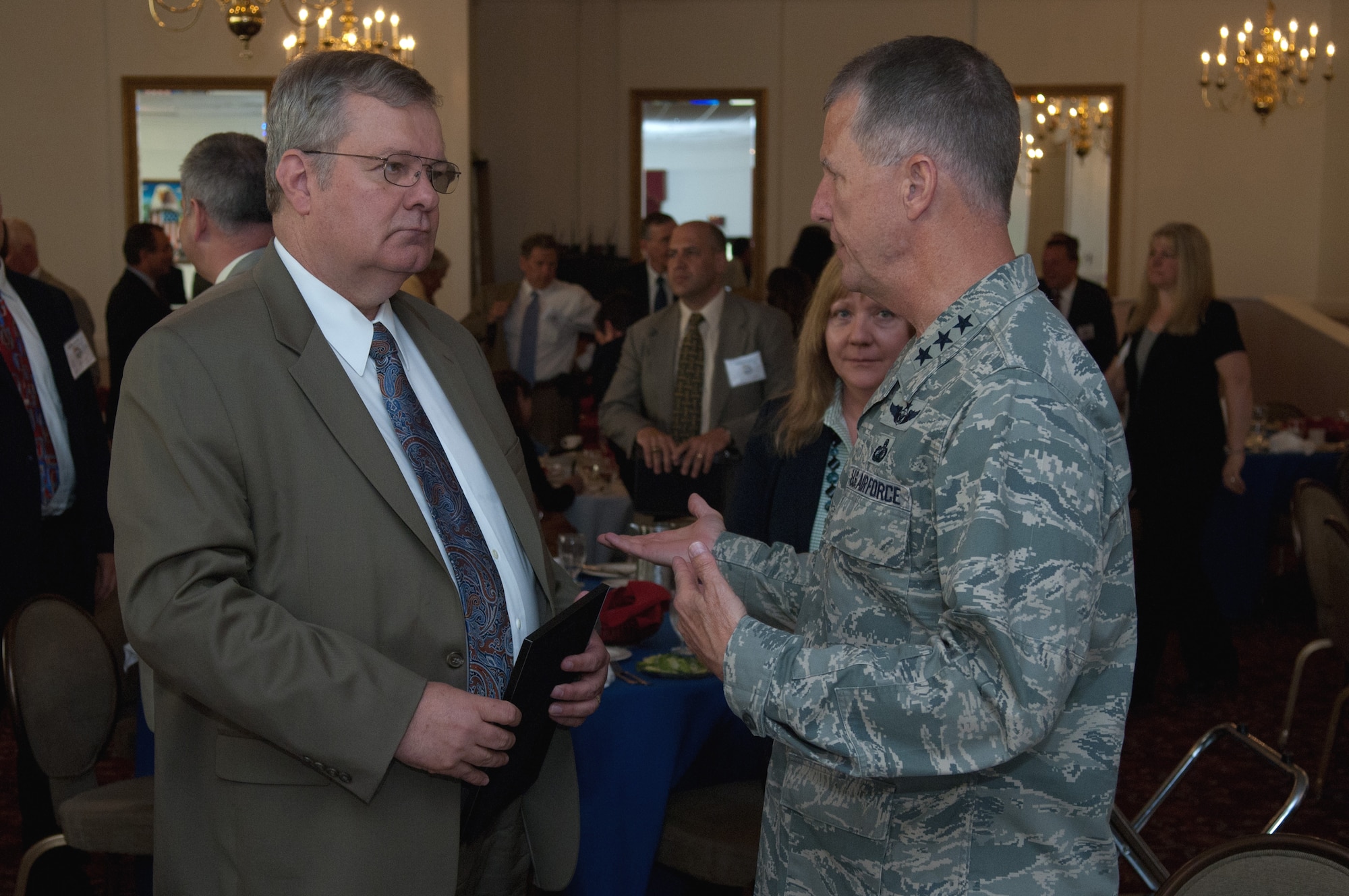 David Van Buren, Air Force service acquisition executive, speaks with Lt. Gen. Ted Bowlds, Electronic Systems Center commander, during the Hanscom Representatives Association meeting June 28.  Mr. Van Buren provided a presentation to the HRA members on effective Air Force acquisition.  (U.S. Air Force photo by Rick Berry) 

