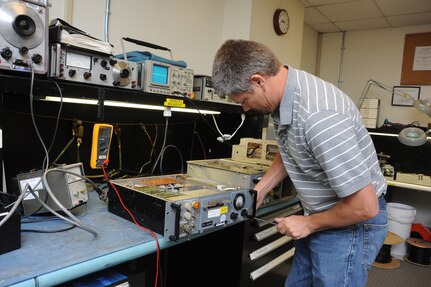 Larry Smith, 902nd Communications Squadron airfield systems maintenance technician, performes maintenance on a ground to air radio at Randolph Air Force Base June 23. Airfield systems maintenance technicians ensure all airfield systems operate to specifications. (U.S. Air Force photo/Rich McFadden) (released)