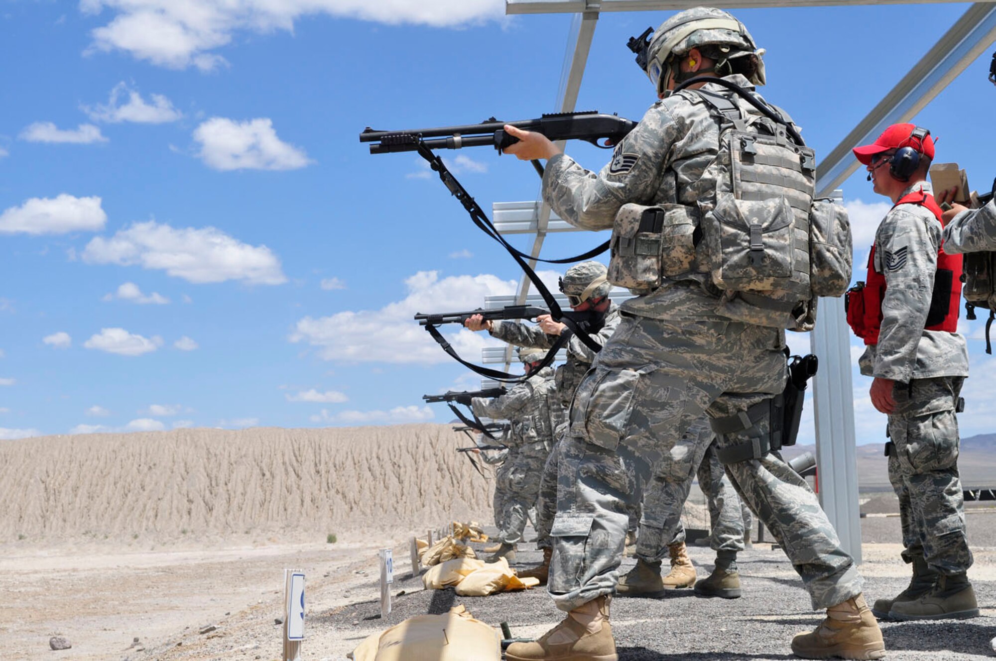 Members of the Nevada Air National Guard's 152nd Airlift Wing practice using 12-gauge shotguns June 14, 2011, on a firing range at Reno Air National Guard Base, Nev. (U.S. Air Force photo)
