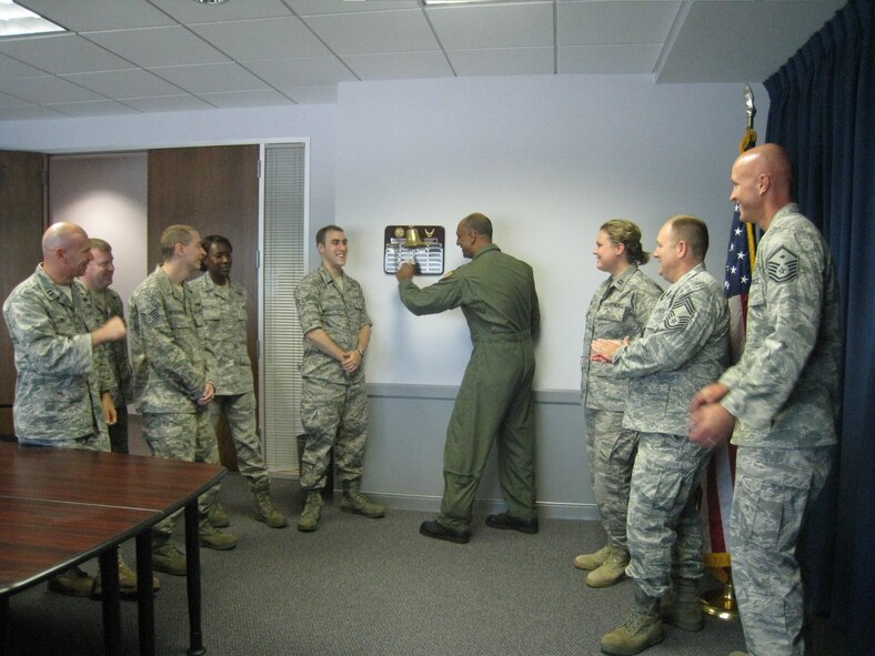 Members of the 317th RCS welcomed their new commander, Lt. Col. Ravi Chaudhary, by having him ring the "Patriot Bell" in the squadron. The ringing of the bell is a squadron tradition which marks the achievement of the squadron’s monthly recruiting goal.  The 317th RCS has met their recruiting goal for 38 consecutive months-- a squadron record. (USAF photo/courtesy photo)