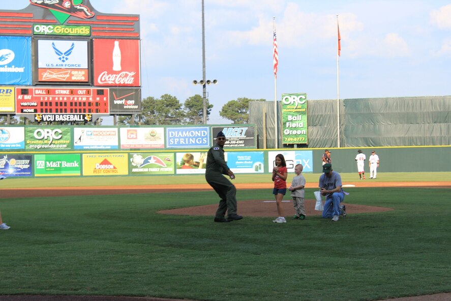 Lt. Col. Ravi Chaudhary, 317th RCS commander, throws out the first pitch at the Richmond Squirrels baseball game in Richmond, Va., during Military Appreciation Night. (USAF photo/courtesy photo)