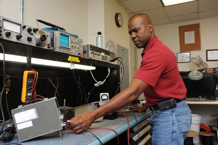 Rene Allanby, 902nd Communications Squadron airfield systems maintenance technician, prepares test equipment needed to perform maintenance on a ground to air radio at Randolph Air Force Base June 23 . Airfied systems maintenance technicians ensure all airfield systems operate to specifications. (U.S. Air Force photo/Rich McFadden) (released)