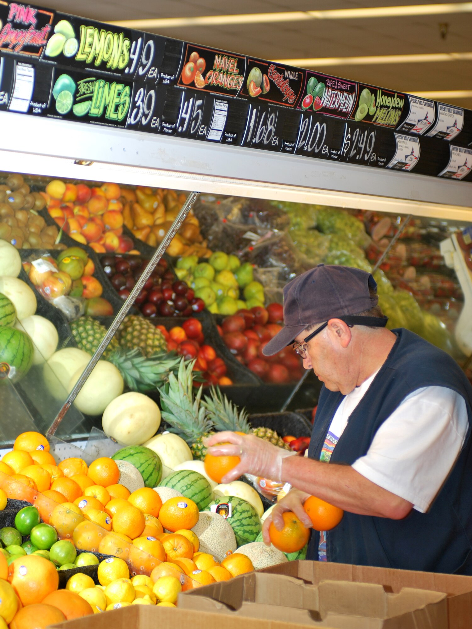 Joseph R. Gallegos, commissary produce store associate, stocks the fruit after the lunch rush at the Cannon Air Force Base commissary, June 29, 2011. Mr. Gallegos will be working when the commissary tests the 11a.m. to 9 p.m. extended hours of operation every Thursday in July. The commissary worked with employees to ensure that all departments, to include the bakery, deli, and meat departments, will be open during the trial hours.  (U.S. Air Force photo by Staff Sgt. Delia Marchick)(RELEASED)