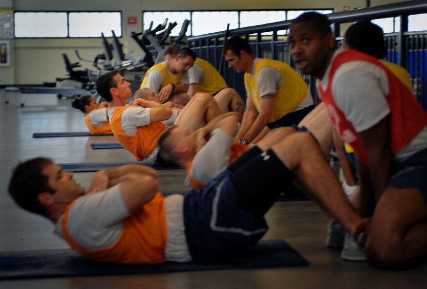 Moody members conduct the sit-up portion of their physical training test at Moody Air Force Base, Ga., June 28, 2011. The PT test helps to ensure Airmen are physically capable of performing duties at home station and when downrange. (U.S. Air Force photo by Airman 1st Class Douglas Ellis/Released)