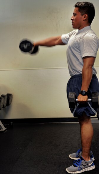 U.S. Air Force Senior Airman Jonathan Gonzales, 41st Helicopter Maintenance Unit aerospace propulsions journeyman, lifts weights at the Freedom I Fitness Center at Moody Air Force Base, Ga., June 28, 2011. Lifting weights increases the body’s lean muscle, giving it a higher resting metabolic rate which can decrease stored body fat. (U.S. Air Force photo by Airman 1st Class Douglas Ellis/Released)