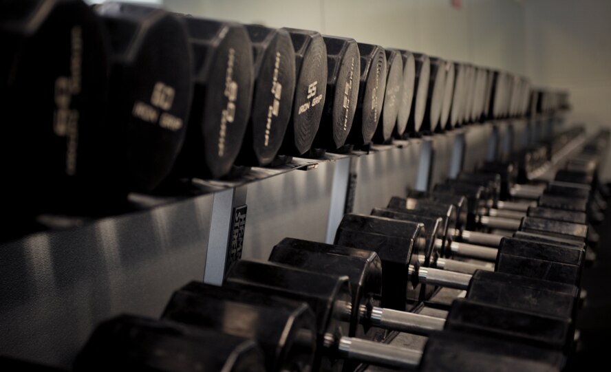 Dumbbells rest on a rack at the Freedom I Fitness Center at Moody Air Force Base, Ga., June 28, 2011. Dumbbells offer an increased range of motion and plenty of overload to the muscles when working out. (U.S. Air Force photo by Airman 1st Class Douglas Ellis/Released)