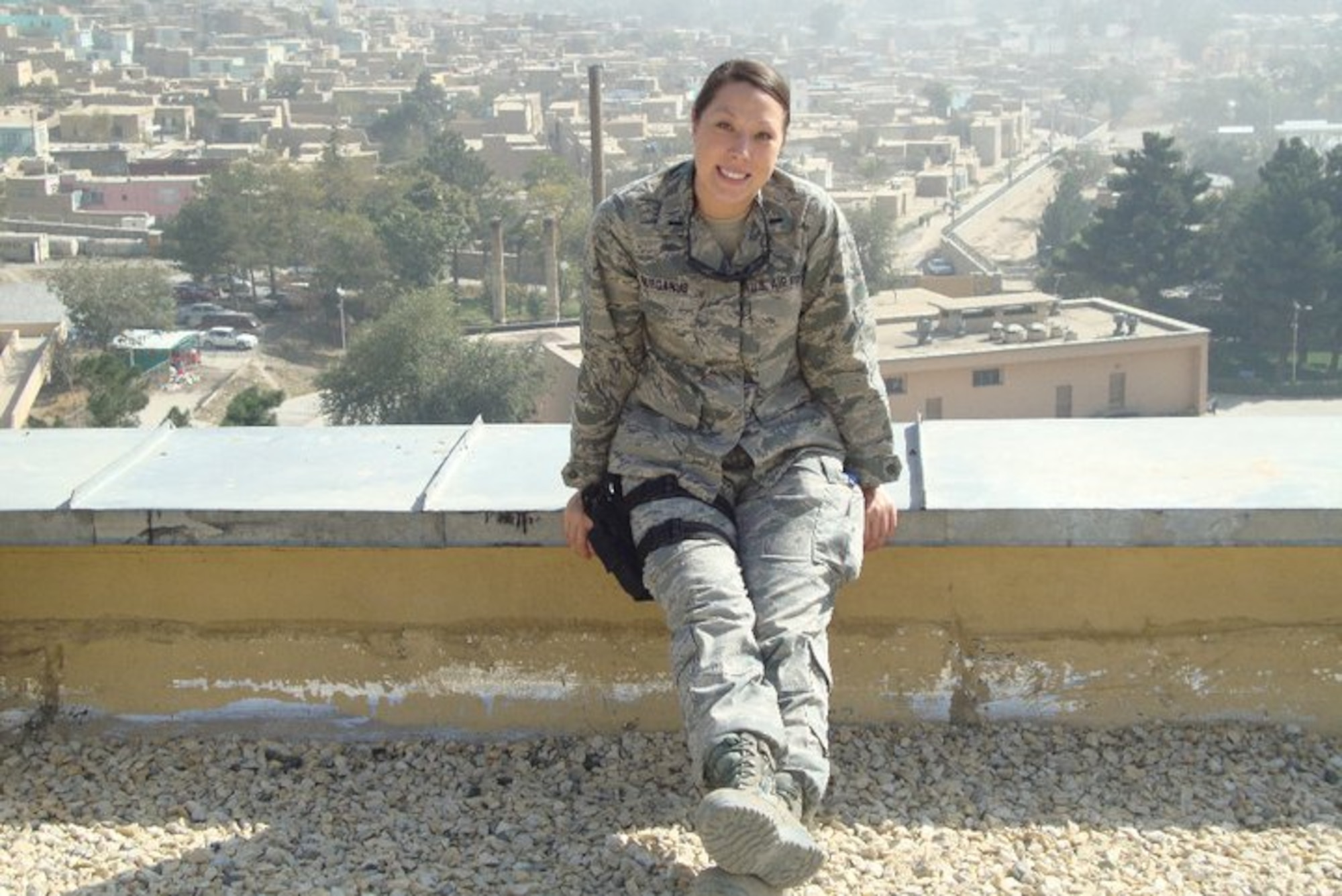 First Lt. Jamie Gurganus is pictured on the roof of the Kabul Hospital during her deployment to Afghanistan.  Behind her is the Kabul skyline. (Photo provided)