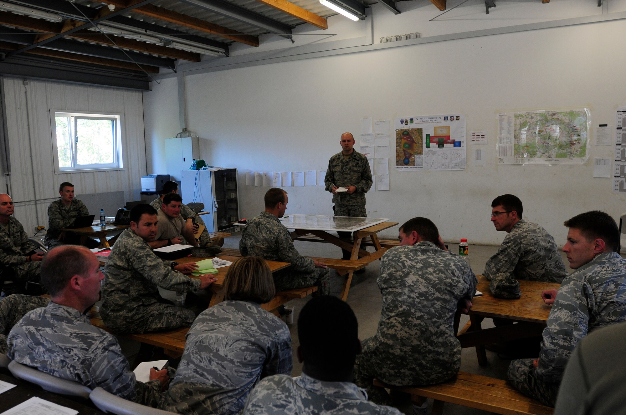 Capt. Ruven Yarbrough, exercise deputy director with the 4th Air Support Operations Group, leads a daily lessons-learned discussion after the day’s training activities at Allied Strike 2011, held at Grafenwoehr Training Area, Germany, June 27, 2011. Allied Strike is Europe’s premier Close Air Support exercise, held annually to conduct robust, realistic CAS training that helps build partnership capacity among Allied NATO nations and refine the latest operational CAS tactics. (U.S. Air Force photo by Airman 1st Class Desiree W. Esposito)