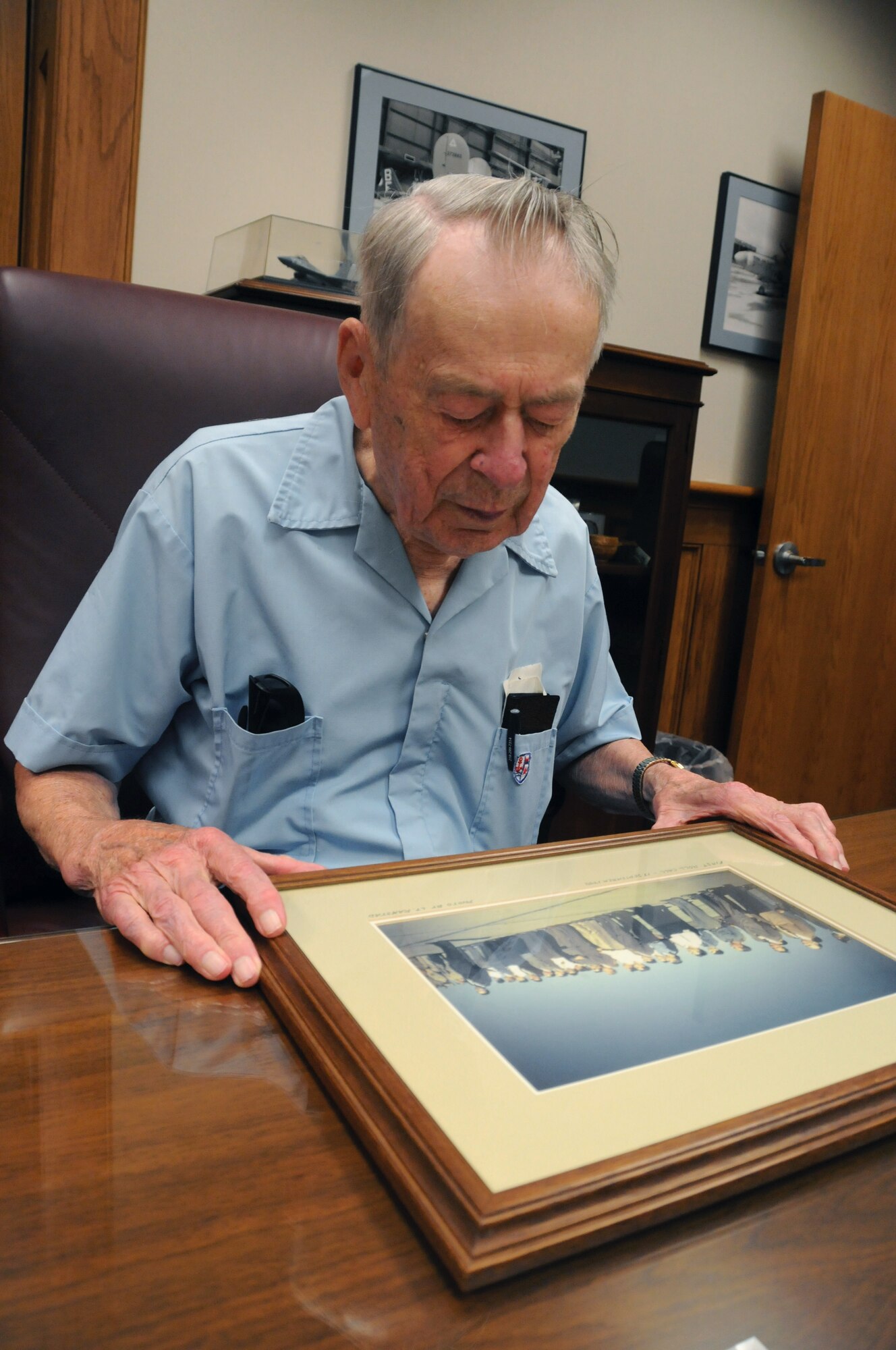 Captain Howard Ramstad (Ret.) reflects on a photograph taken by him of the original members of the 148th Fighter Wing. Capt. Ramstad, a founding member of the 148th Fighter Wing, was a pilot who flew the P-51 Mustang among other aircraft throughout his career.  