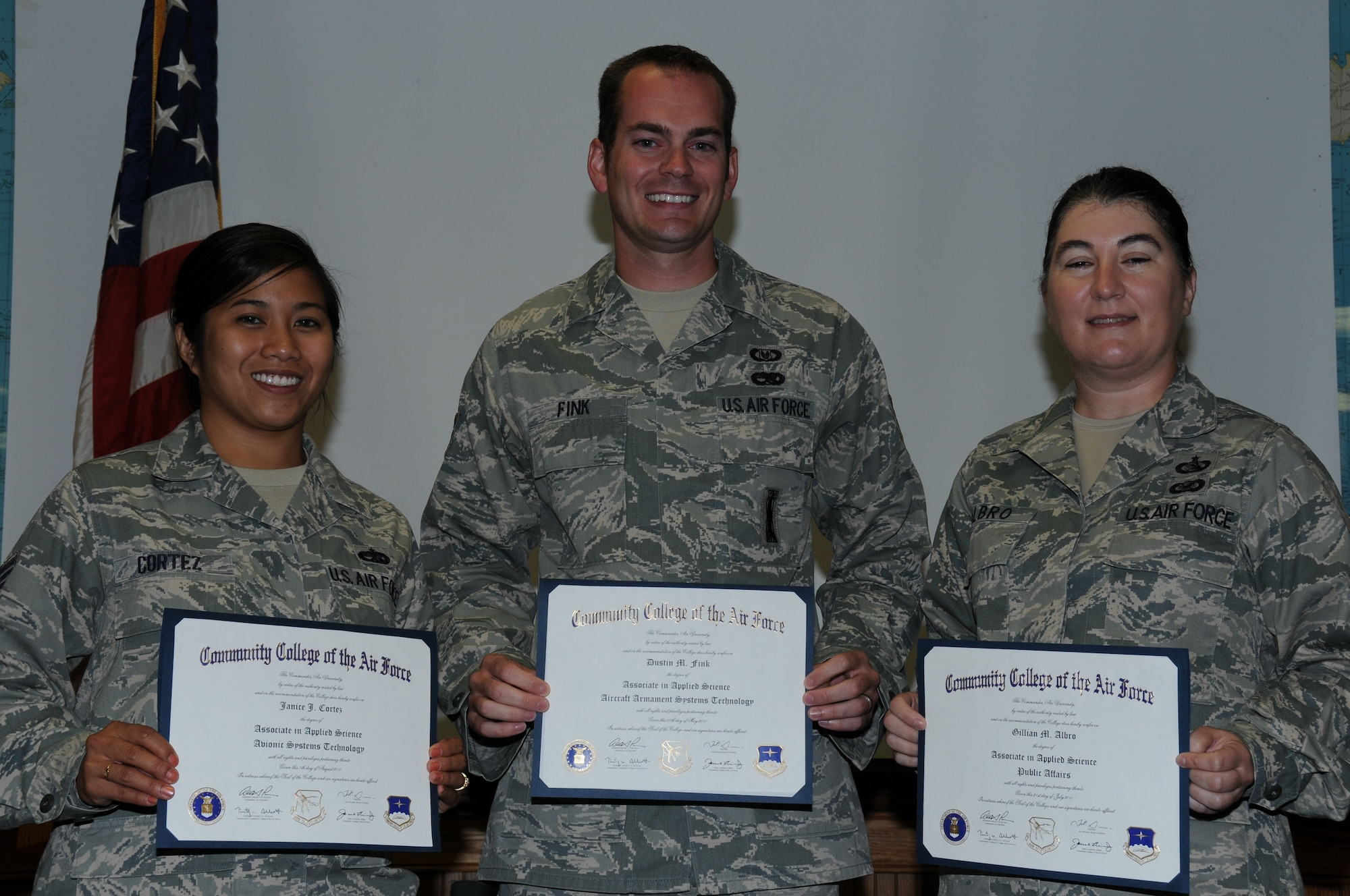 From left to right, Tech. Sgt. Janice Cortez, Staff Sgt. Dustin Fink and Master Sgt. Gillian Albro show-off their degrees from the Community College of the Air Force. (USAF photo by SSgt. Terrica Jones, 916ARW/PA)