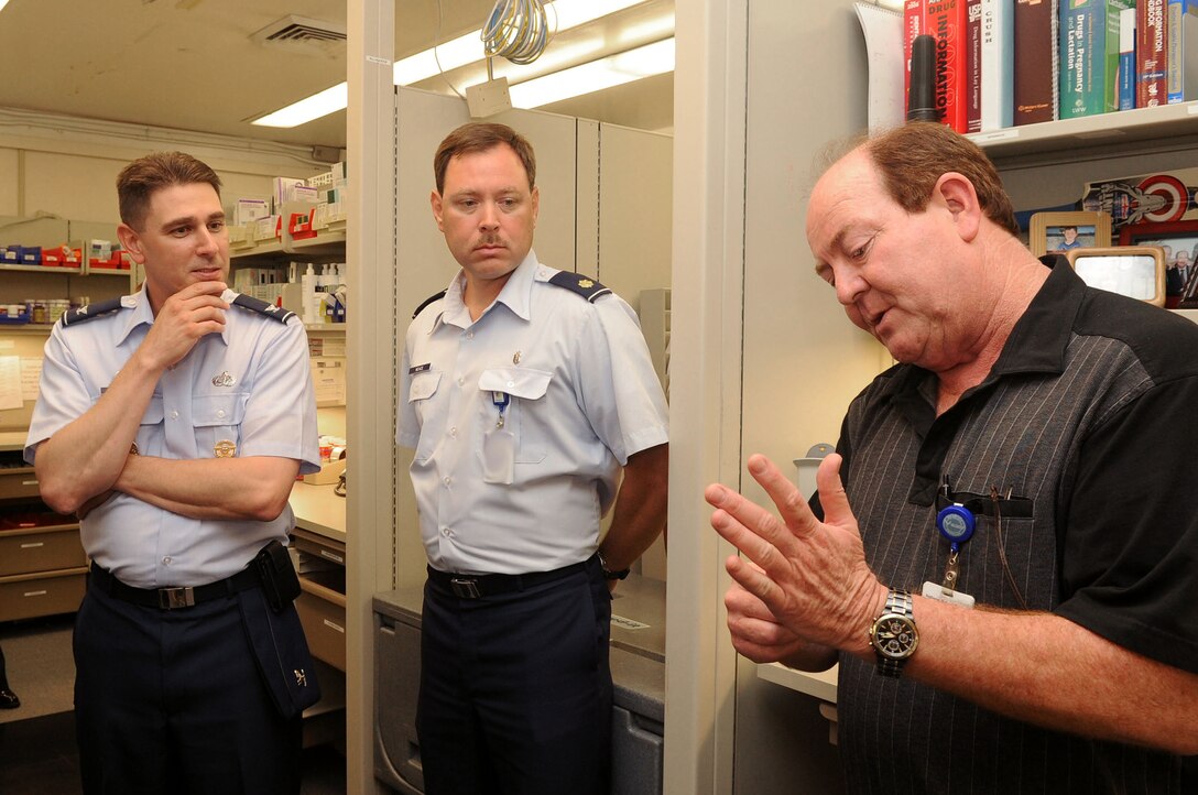 From left, Col. Korvin Auch, 633rd Air Base Wing commander, and Maj. Michael Neave, 633rd Medical Support Squadron chief of pharmacy, receive a briefing on how to identify pills from Kevin Macintosh, contracted pharmacist, during the 633rd Medical Group visit at Langley Air Force Base, Va., June 27, 2011. The base commander toured the facility to better understand the needs of the people.  (U.S. Air Force photo by Airman 1st Class Racheal Watson/Released)