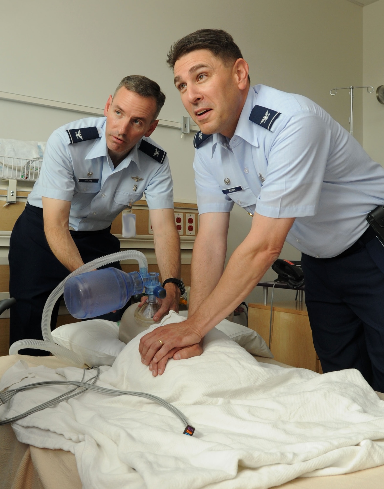 From left, Col. Eric Stone, 633rd Medical Group commander, and Col. Korvin Auch, 633rd Air Base Wing commander, simulate administering CPR during the medical group visit at Langley Air Force Base, Va., June 27, 2011. The base commander toured the facility to establish a rapport and receive a mission briefing from the staff. (U.S. Air Force photo by Airman 1st Class Racheal Watson/Released)