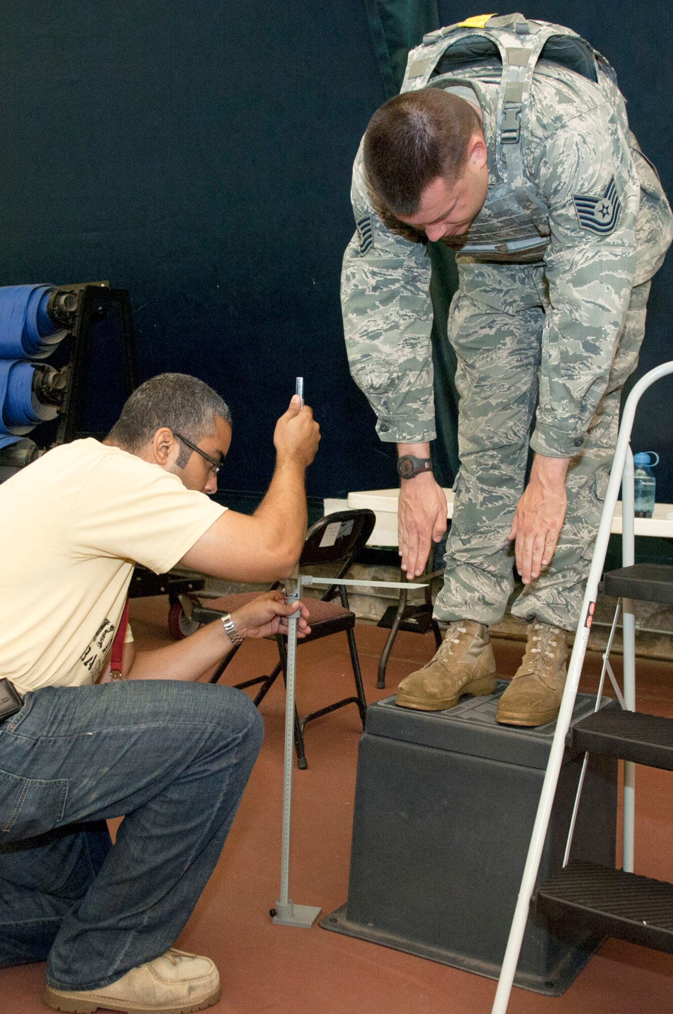HANSCOM AIR FORCE BASE, Mass. – Christopher Reid, from the Human Factors team, Natick Soldier Research, Development and Engineering, measures range of motion of Tech Sgt. Matthew Ellgen while he wears body armor in the Tennis Bubble June 22. The Natick team visited Hanscom and worked with 66th Security Forces Squadron members to make sure body armor protects while not interfering with an individual’s ability to maneuver. (U.S. Air Force photo by Rick Berry)