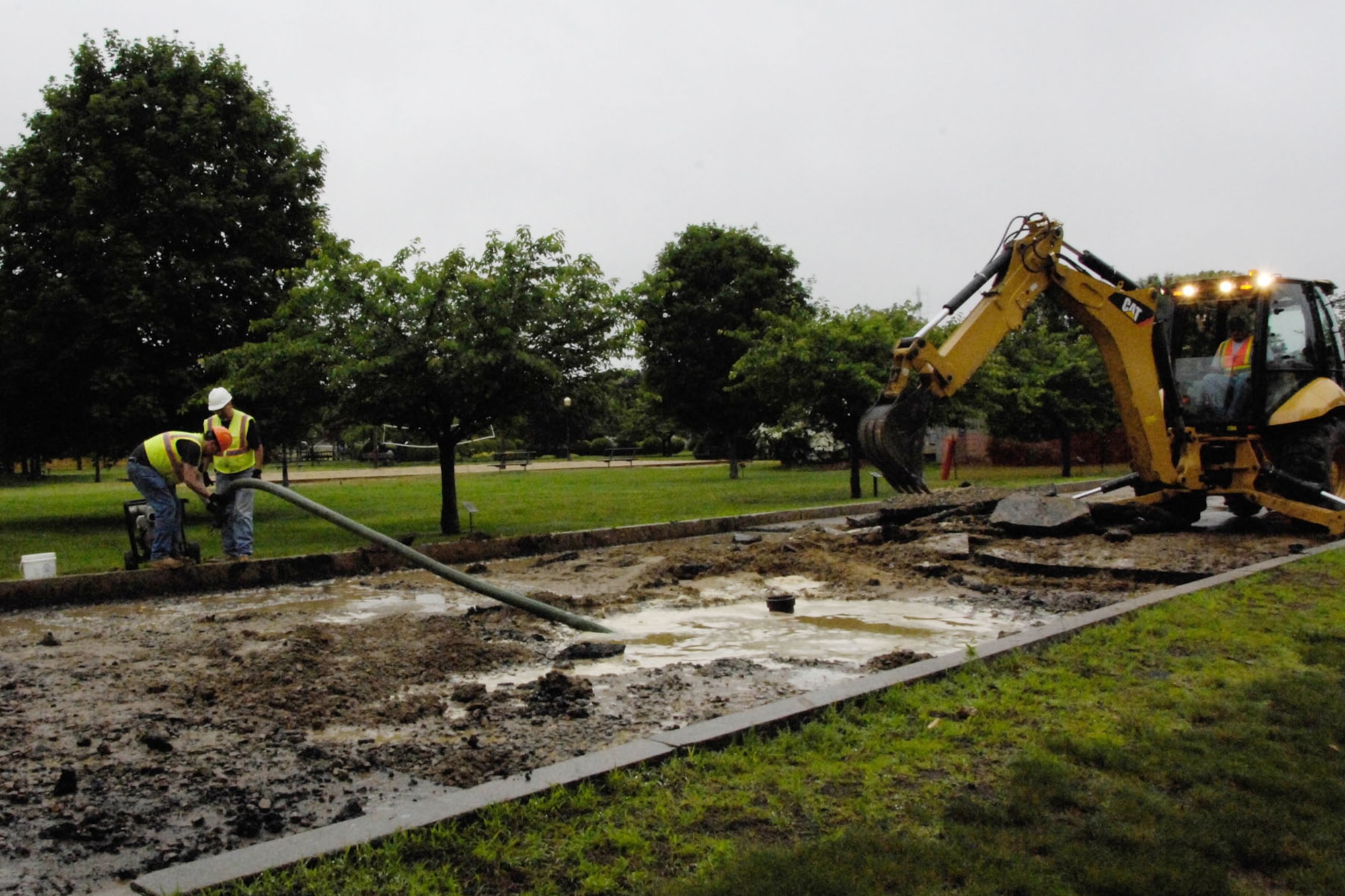 HANSCOM AIR FORCE BASE, Mass. – Crews work to repair a water main break along Eglin Street June 24. As a result of the break, the Child Development Center was closed Friday. (U.S. Air Force photo by Linda LaBonte Britt)