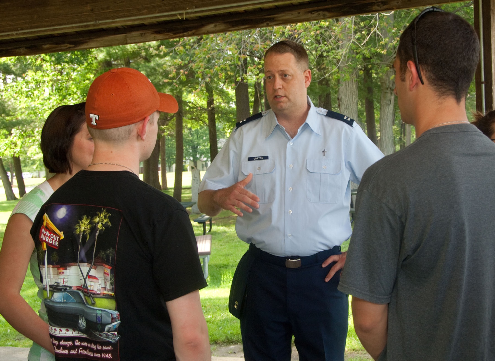 HANSCOM AIR FORCE BASE, Mass. – Airman 1st Class Michelina Bonavito, Airman 1st Class Alexander Burton and Airman Thomas Membrino speak with Chaplain Michael Gorton (middle) at the dorm dinner held at Castle Park June 27. The Company Grade Officers Council sponsored the monthly dinner to allow dorm residents to casually interact with various leaders and organizations across the base. (U.S. Air Force photo by Mark Herlihy)