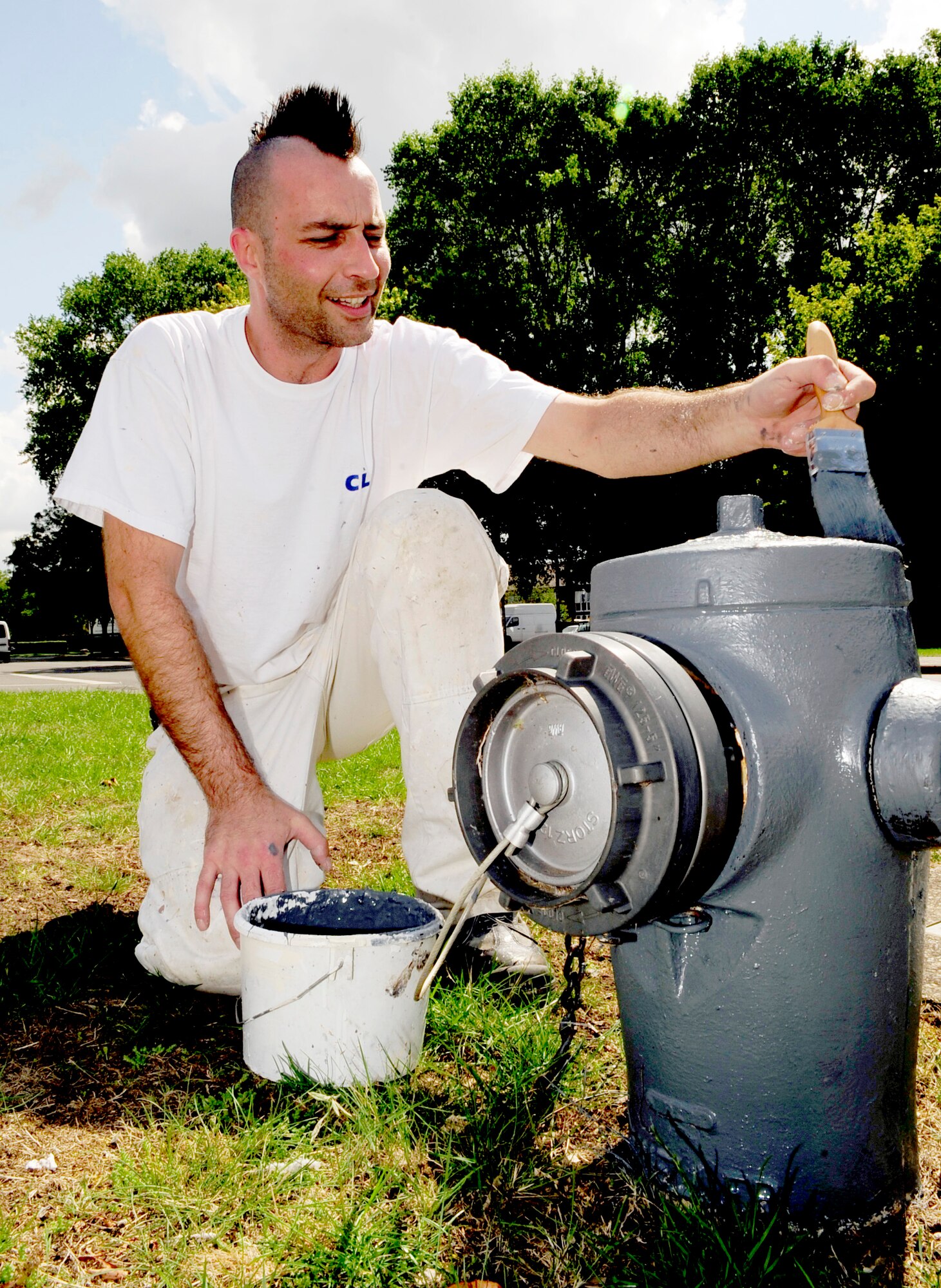 RAF MILDENHALL, England – Mark Arnold, a local contractor, applies primer to a fire hydrant before painting it here June 29, 2011. Fire hydrants around the base are being repainted to make them more recognizable for emergency response personnel and to beautify the base. (U.S. Air Force photo/Senior Airman Ethan Morgan)