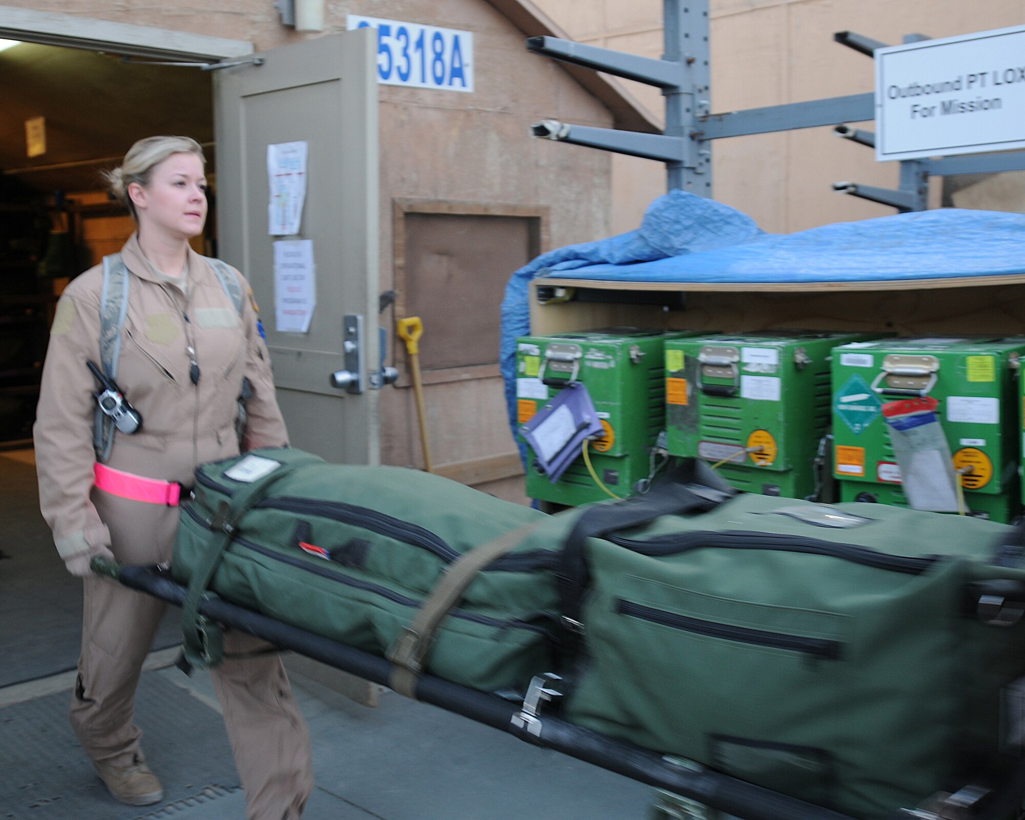 Staff Sgt. Laura Zulkosky, 455th Expeditionary Aeromedical Evacuation Flight 3rd medical technician, carries a litter to be loaded onto a C-130 Hercules at Bagram Airfield, Afghanistan, June 28, 2011. (U.S. Air Force photo by Senior Airman Krista Rose)