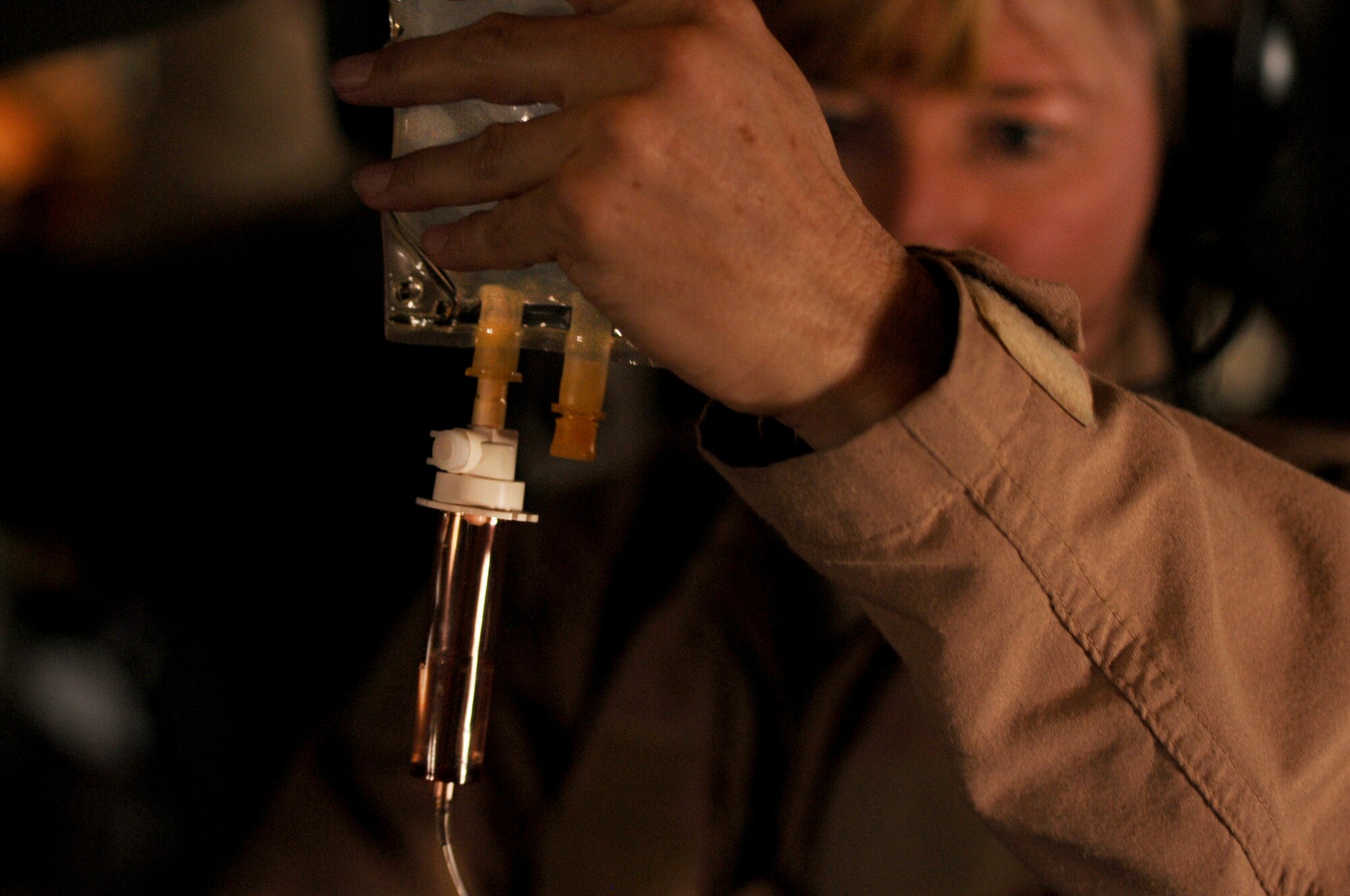 Lt. Col. Sherry Hemby, 455th Expeditionary Aeromedical Evacuation Flight commander, prepares patient medication while transporting injured service members to Bagram Airfield, Afghanistan, June 28, 2011. (U.S. Air Force photo by Senior Airman Krista Rose)
