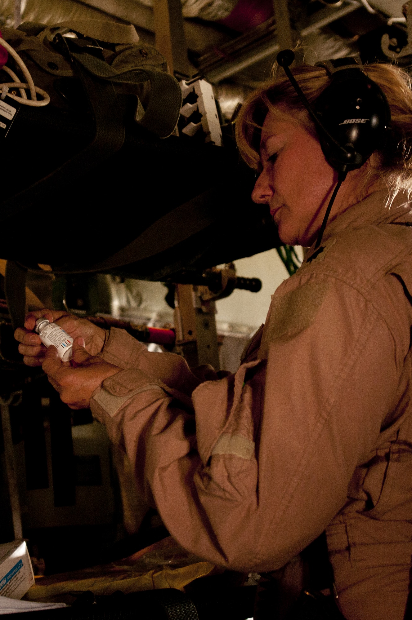 Lt. Col. Sherry Hemby, 455th Expeditionary Aeromedical Evacuation Flight commander, reviews patient medication while transporting patients to Bagram Airfield, Afghanistan, June 28, 2011. (U.S. Air Force photo by Senior Airman Krista Rose)