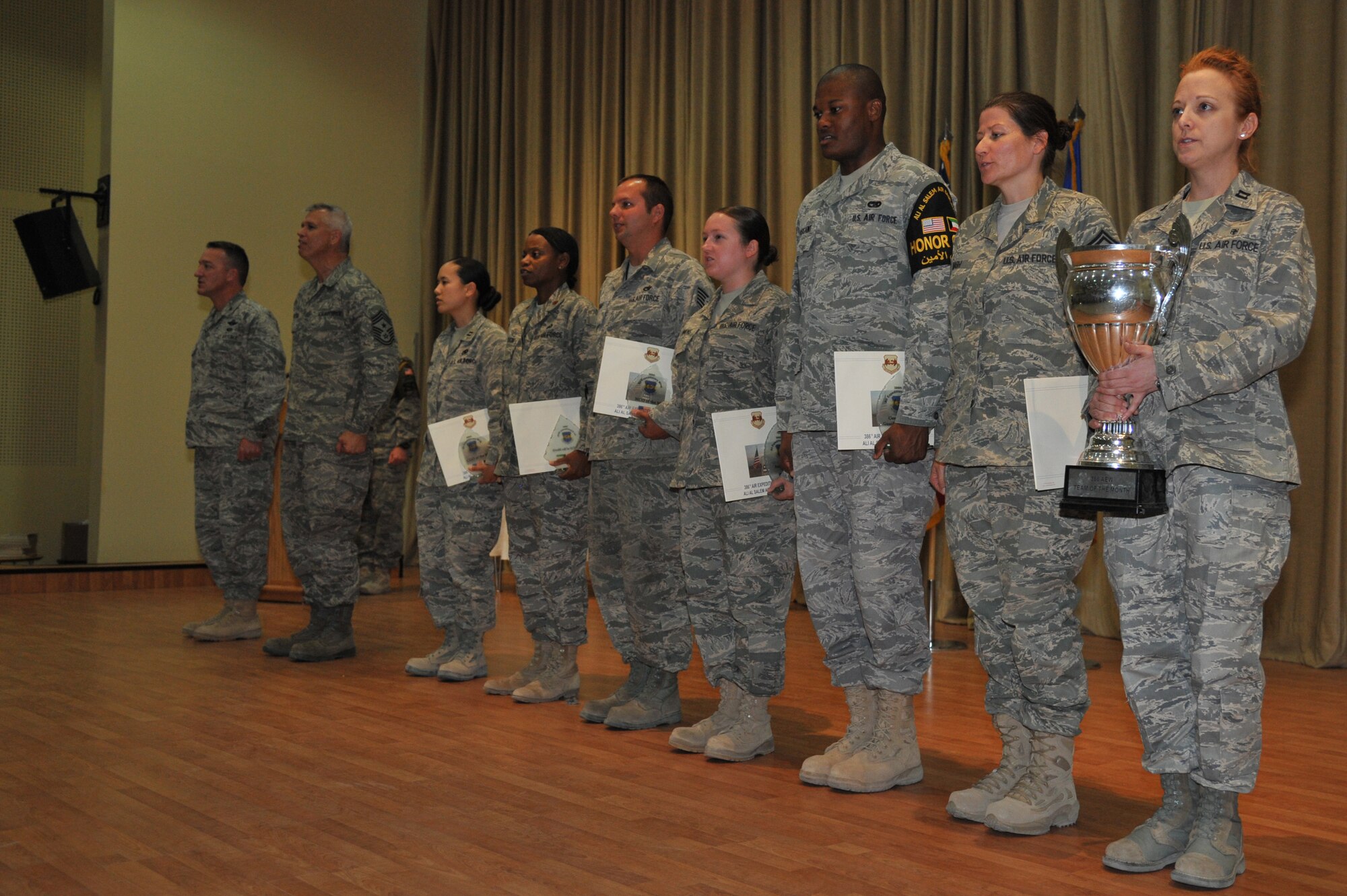 Col. Patrick Mordente, 386th Air Expeditionary Wing commander, Chief Master Sgt. Mitchell Balutski, 386th AEW command chief, along with the monthly award winners, recite the Airman’s Creed at an undisclosed location in Southwest Asia June 29. (U.S. Air Force photo by Master Sgt. Carlotta Holley) 