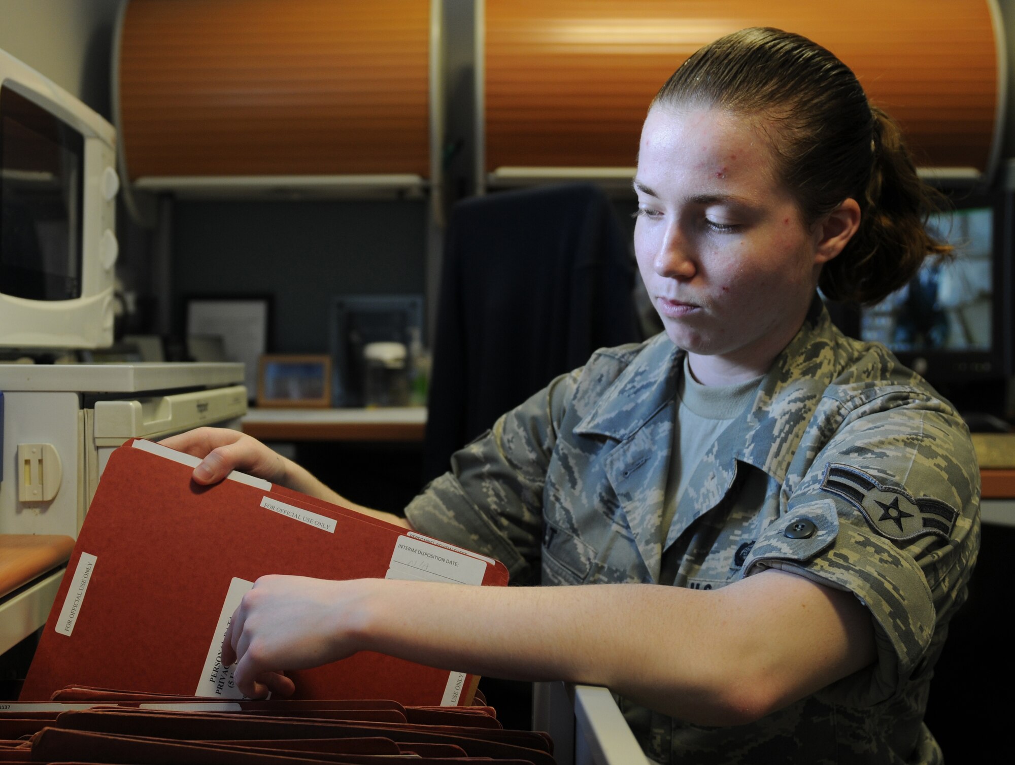 ROYAL AIR FORCE LAKENHEATH, England - Airman 1st Class Jessica Tilt, 48th Force Support Squadron force management apprentice, files papers Military Personnel Function building on June 28, 2011. Airman Tilt was nominated for a Liberty Spotlight because she displays the core value of 'Excellence in All We Do'. (U.S. Air Force photo/Airman Cory Payne)