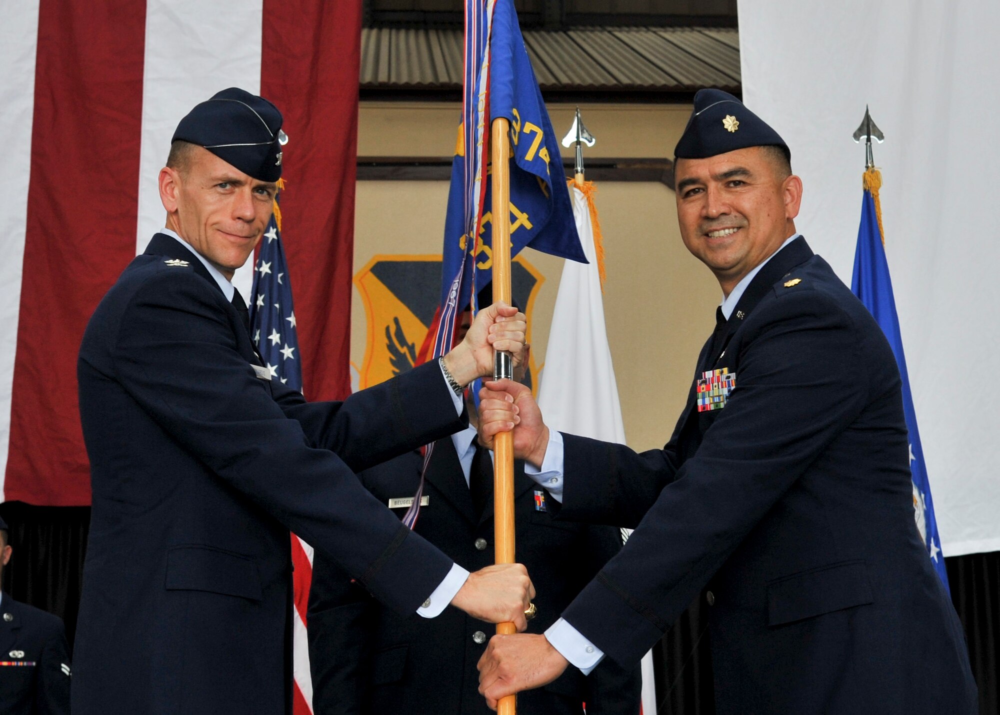 YOKOTA AIR BASE, Japan -- Col. Christopher S. Mardis, 374th Maintenance Group commander passes the guidon to Maj. Danny K. Makalena , 374th Aircraft Maintenance Squadron commander, during a change of command ceremony June 28, 2011, Yokota Air Base, Japan. The passing of the guidon symbolizes Major Makalena assuming command. (U.S. Air Force photo/Senior Airman Andrea Salazar)