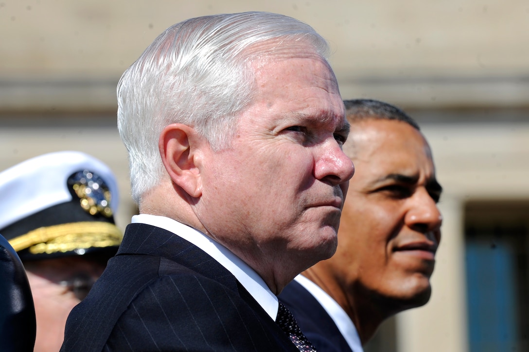 Defense Secretary Robert M. Gates, President Barack Obama, and Navy Adm. Mike Mullen, chairman of the Joint Chiefs of Staff, listen to the U.S. Army Old Guard Fife and Drum Corps during the Armed Forces Farewell Tribute to honor Gates at the Pentagon, June 30, 2011.
