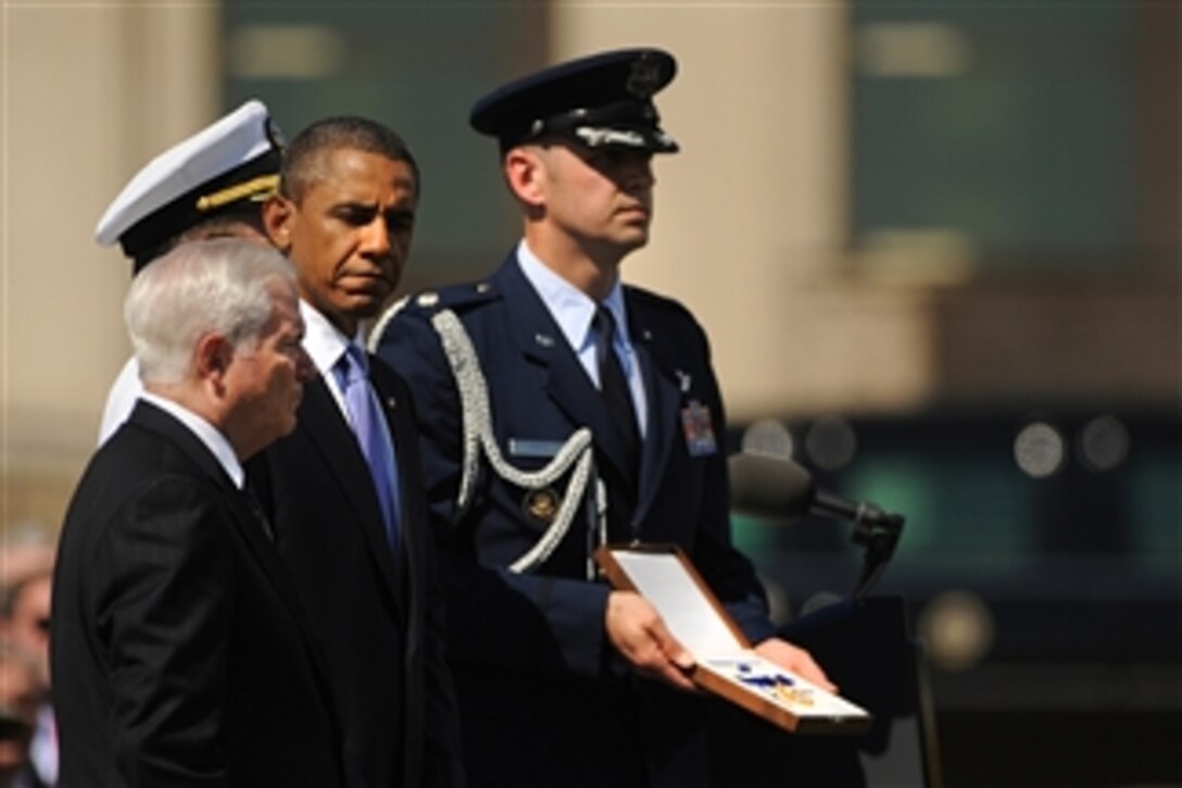 President Barack Obama presents Secretary of Defense Robert M. Gates with the Presidential Medal of Freedom, the highest civilian award a president can bestow, during the Armed Forces Farewell Tribute to honor Gates at the Pentagon on June 30, 2011.  