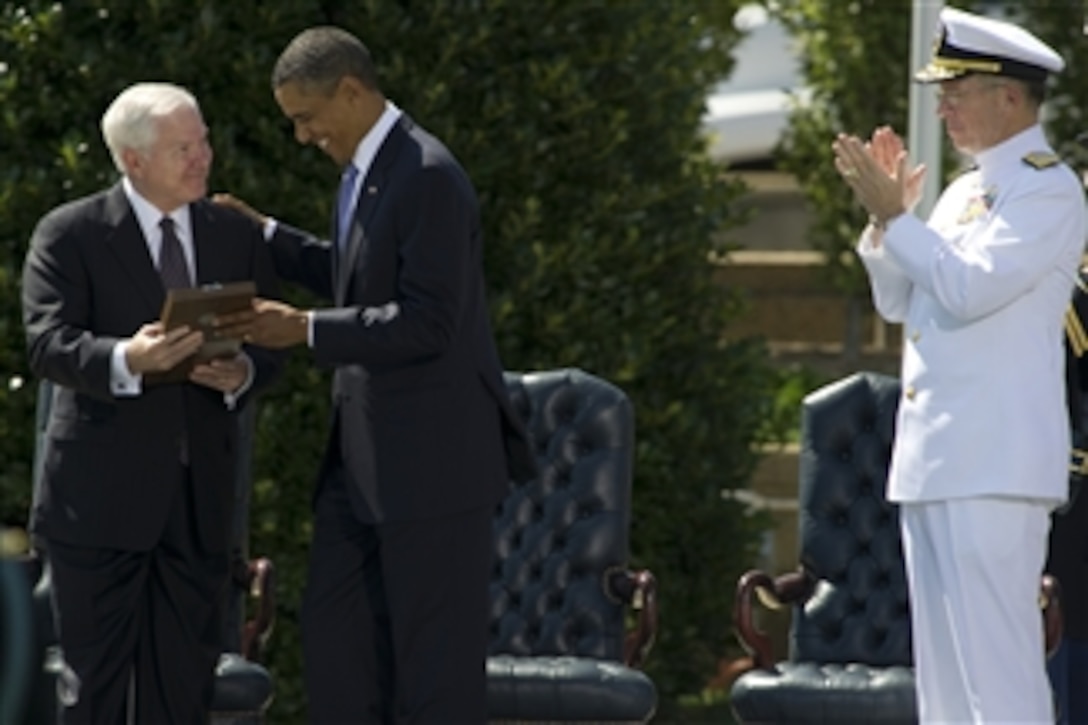 President Barack Obama presents Secretary of Defense Robert M. Gates with the Presidential Medal of Freedom at an Armed Forces Farewell Tribute held in his honor at the Pentagon on June 30, 2011.  