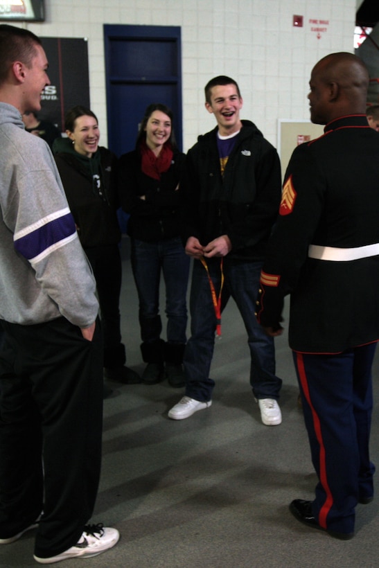 A Marine with Marine Corps Recruiting Station Albany, speaks with Albany area high school students at the Times Union Center during the Section II Boys Basketball semifinals here. Marines with Recruiting Station Albany attend several events a month at the Times Union Center to raise awareness of the Marine Corps and to generate interest in the opportunities the Marine Corps provides.