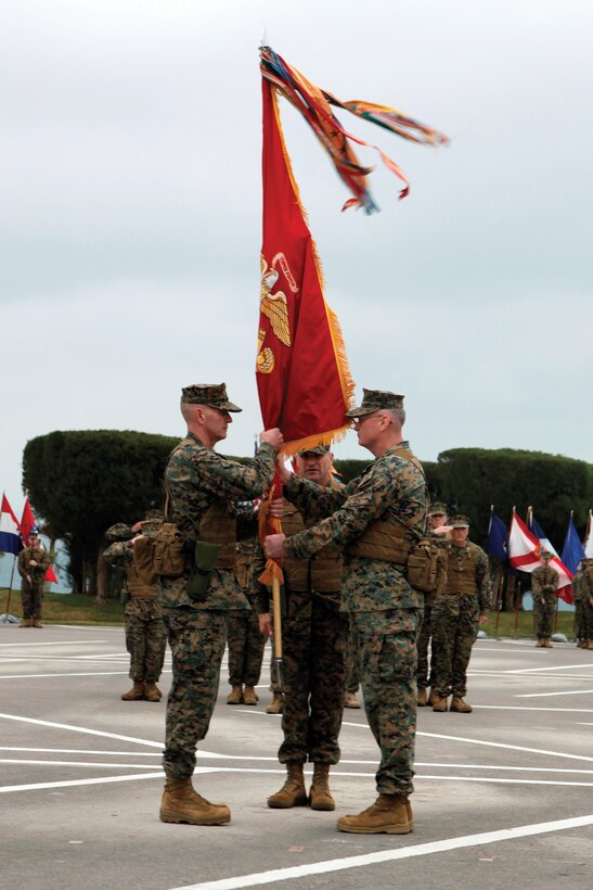 Maj. Gen. James B. Laster, right, outgoing commanding general of 3rd Marine Division, III Marine Expeditionary Force, passes the division colors to Brig. Gen. Mark A. Brilakis, the division’s incoming commanding general, during a change of command ceremony March 1 at the division’s headquarters on Camp Courtney. Brilakis, who has been selected for promotion to major general, promised those watching the ceremony, “I will do my best for these Marines and sailors.”