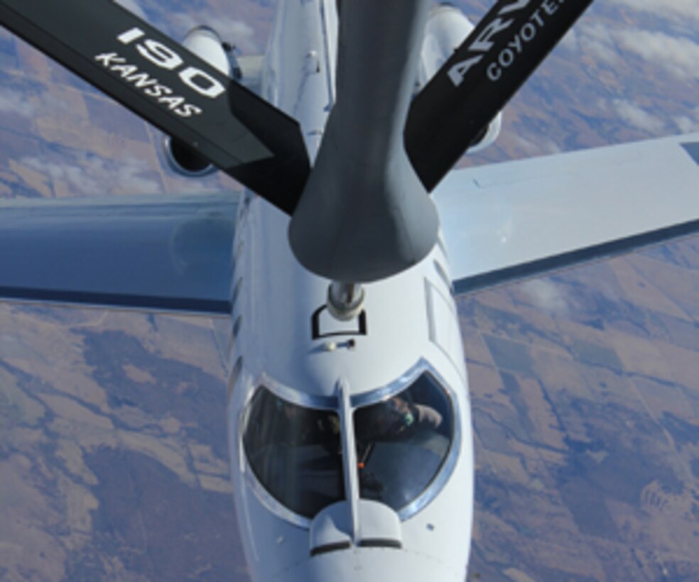 A Learjet used as a surrogate for an unmanned aircraft approaches the refueling boom of a modified 190th Air Refueling Wing KC-135 during a recent flight test for the U.S. Air Force Research Laboratory's Automated Aerial Refueling (AAR) program.