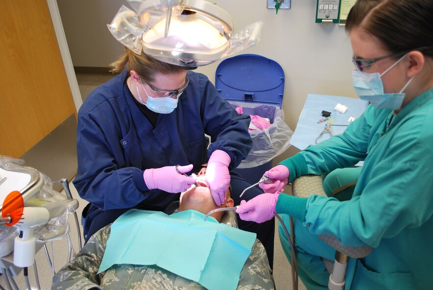 HOLLOMAN AIR FORCE BASE, N.M. – Capt. (Dr.) Rebecca Brinks, a dentist with the 49th Medical Group Dental Clinic, and Senior Airman Sarah Swaim, a dental technician also with the dental clinic, give an anesthetic to a patient prior to filling a cavity during an annual dental visit. Annual dental exams are performed to ensure military members have healthy mouths to ensure they are operationally ready and to prevent diseases such as gingivitis, periodontis and cavities. (Photo courtesy of the 49th Medical Group Dental Clinic)