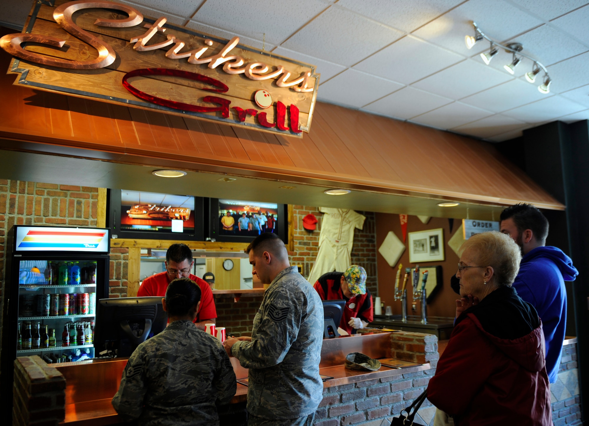 MOUTAIN HOME AIR FORCE BASE, Idaho – Customers order food from the newly renovated Strikers Grill located inside the bowling center March 1. The grill opened Feb. 25 after three and a half months of renovation, a project that cost more than $200,000. The modernized restaurant now features two 55-inch televisions, an eight-foot television and two party rooms.  (U.S. Air Force photo by Airman 1st Class Renishia Richardson)