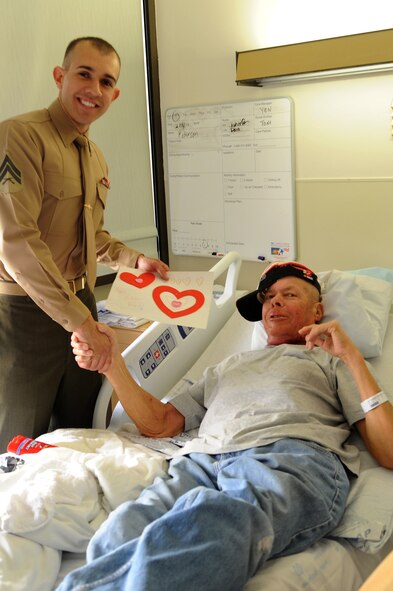 U.S. Marine Cpl. Victor Gomez, Administrative Clerk, Twenty-nine Palms, Calif., gives a Valentine's card to U.S. Army Cpl. Kenith Peterson, a Vietnam veteran at Loma Linda Veterans Hospital, Loma Linda, Calif., Feb. 16, 2011. (U.S. Air Force photo by Tech. Sgt. Christine Jones/Released)