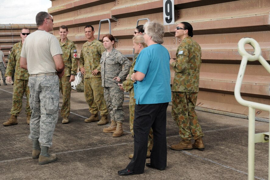 Members of the Royal Australian Air Force (RAAF) Base, Williamtown, Australia medical group work with Chief Master Sgt. Ed Chandler (left) and members of the 132nd Fighter Wing (132FW), Des Moines, Iowa Medical Group during an orientation to the 132FW F-16 aircraft during joint flying operation, "Sentry Down Under" on March 1, 2011.  The 132FW is currently deployed in Australia, working with the RAAF.  (US Air Force photo/Staff Sgt. Linda E. Kephart)(Released)   