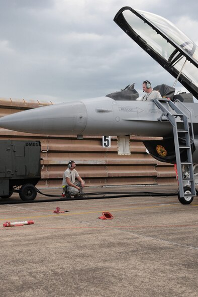 Staff Sgt. Jared Eisenhauer (right) and Tech. Sgt. Josh Jamieson (left) from the 132nd Fighter Wing, Des Moines, Iowa, work on the flight line of the Royal Australian Air Force (RAAF) Base, Williamtown, Australia and de-fuel an F-16 aircraft on March 1, 2011.  The 132FW and RAAF are currently engaged in Dissimilar Air Combat Training mission, "Sentry Down Under".  (US Air Force photo/Staff Sgt. Linda E. Kephart)(Released)   